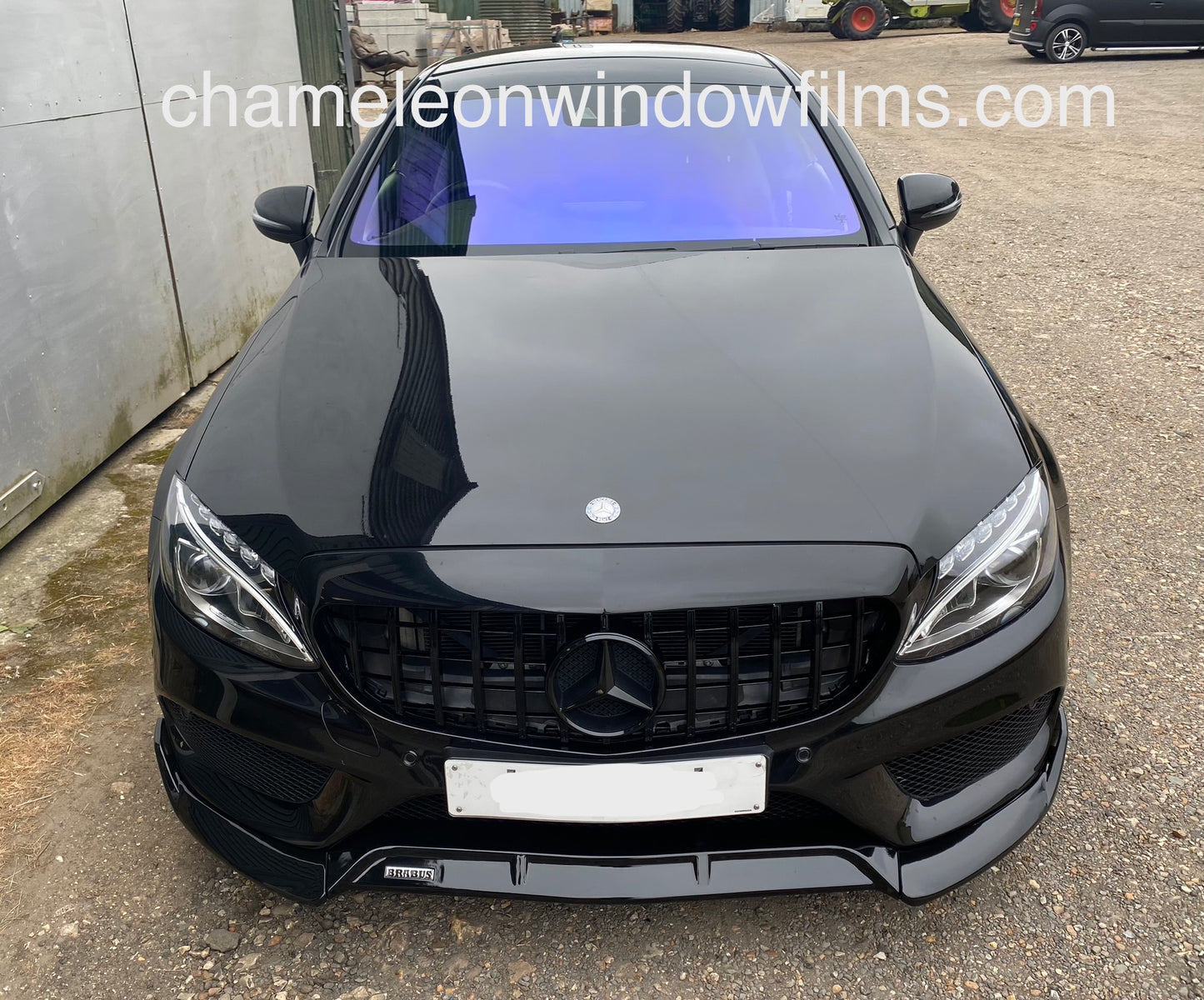 Black car showing blue chameleon windscreen tint installed