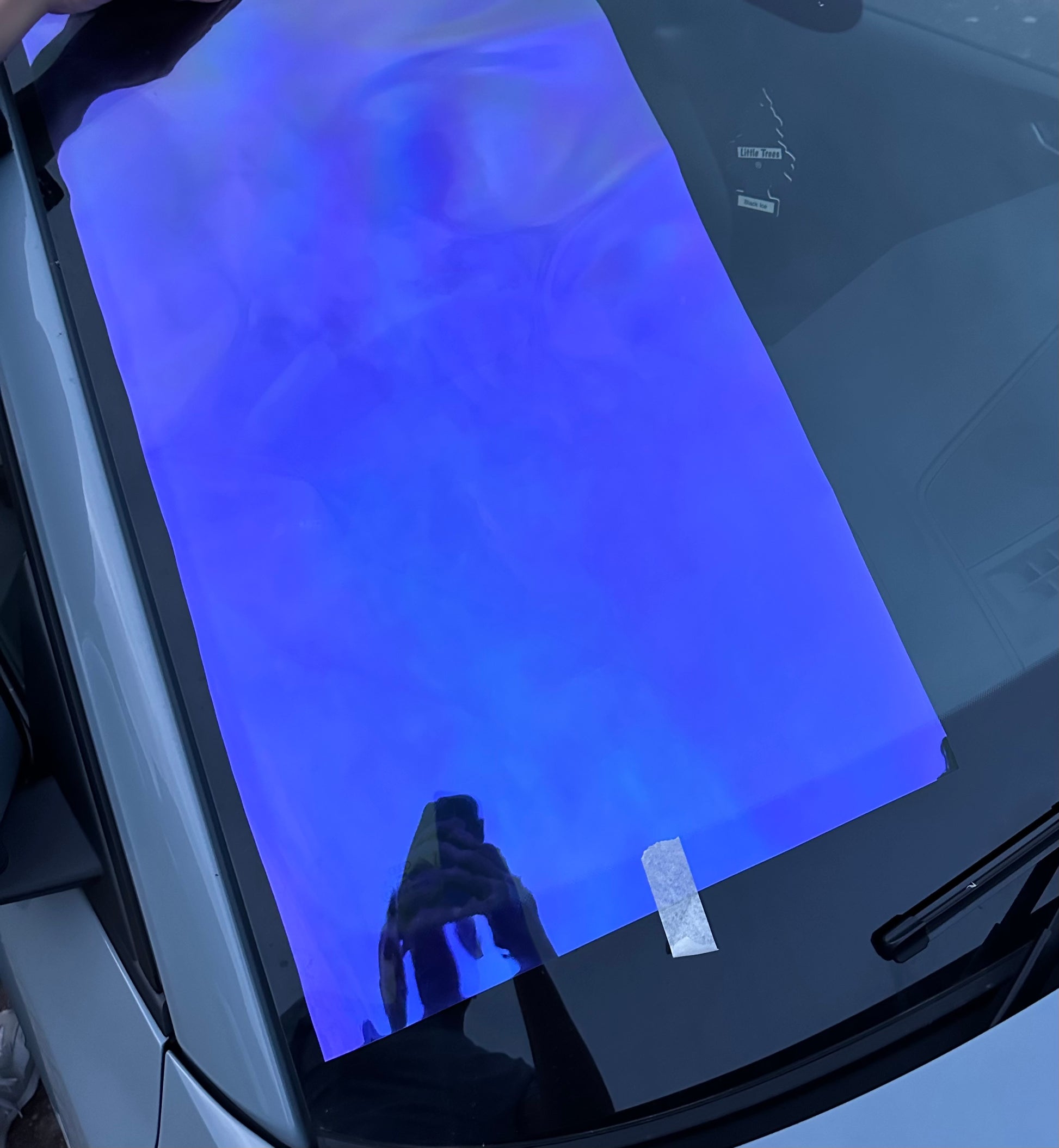 Blue windscreen film placed on car window