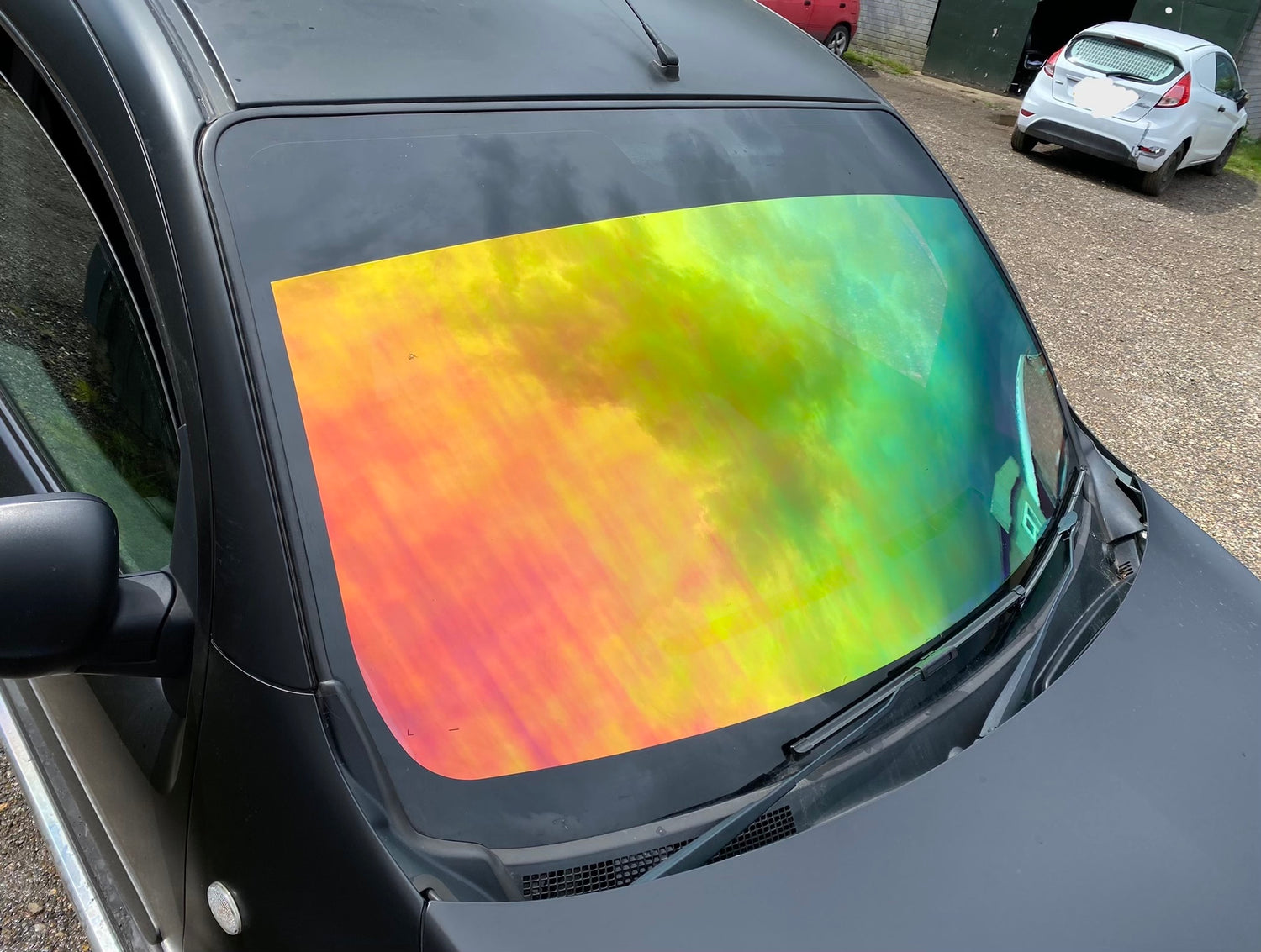 matt black wrapped vehicle with rainbow chameleon windscreen window film UK supplier of window tint