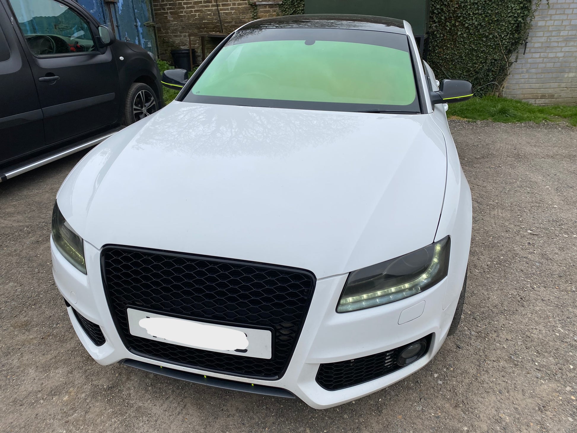 A car with green chameleon window film applied to its windows